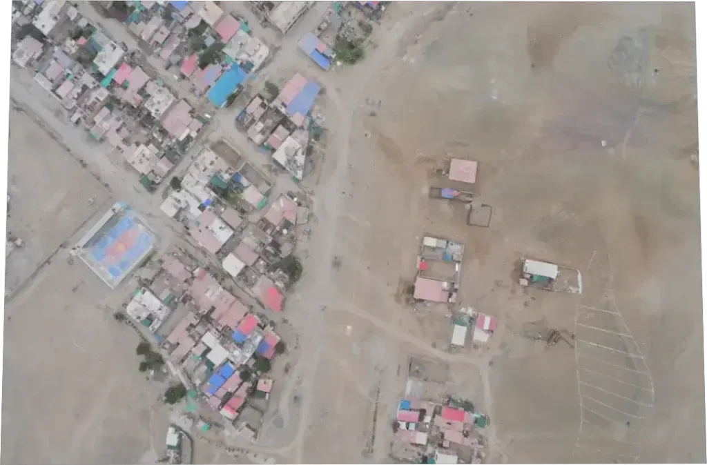 Foto aérea rectificada de un sector con viviendas, cultivos y un camino